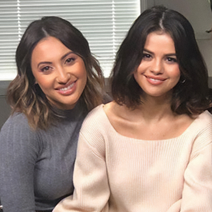 Two women smiling indoors with blinds behind them, related to Selena Gomez under fire kidney donation controversy.