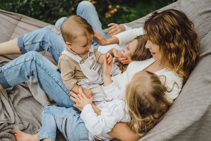 Young siblings and their mom spending time together outdoors, highlighting family dynamics and childhood moments. Young siblings and their mom spending time together outdoors, highlighting family dynamics and childhood moments.