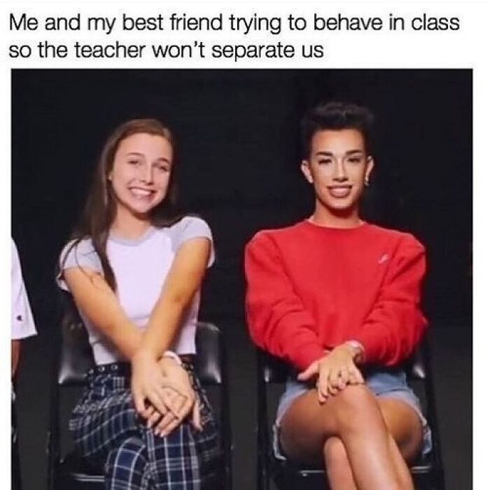 Two friends sitting close together with legs crossed, trying to behave in class as a relatable girly friendship meme.