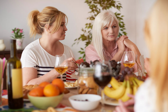 Teen loses patience as golden child cousin dominates celebration, causing tension during family gathering at the dining table.