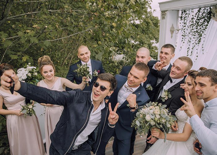 Group of wedding guests taking a joyful selfie, unrelated to step-dad heartbreaking speech about GF and her daughter&rsquo;s indifference.