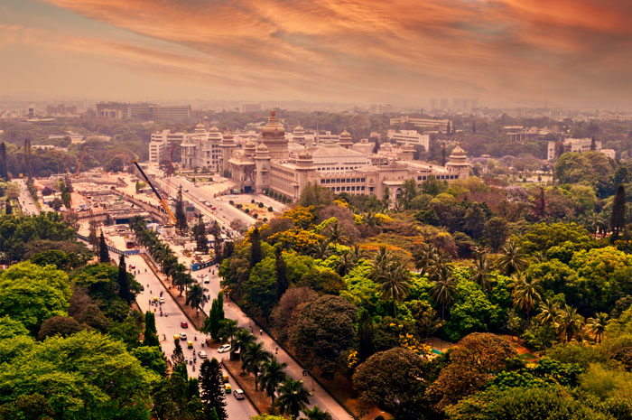 Aerial view of a cityscape at sunset with lush greenery and historical buildings, relating to doctor who argued against wife&rsquo;s autopsy.