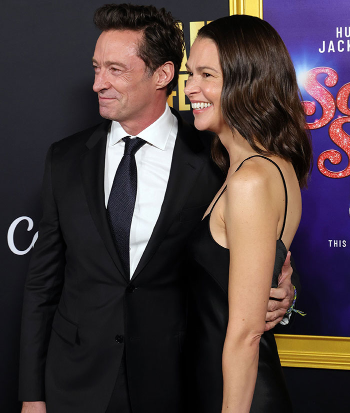 Hugh Jackman and Sutton Foster smiling side by side, displaying body language experts' analysis of their behavior.