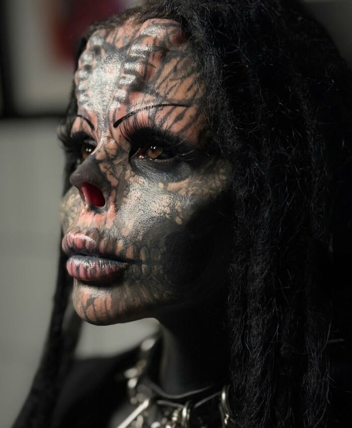 Tattooed woman with facial body art and altered nose, showcasing dramatic before-and-after transformation details.