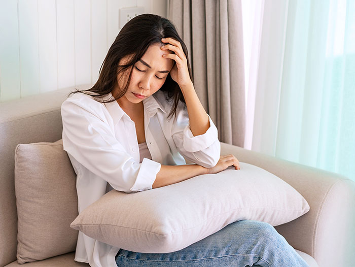 17-year-old teenager looking upset and stressed while sitting on a couch, venting about sharing a birthday with grandma.