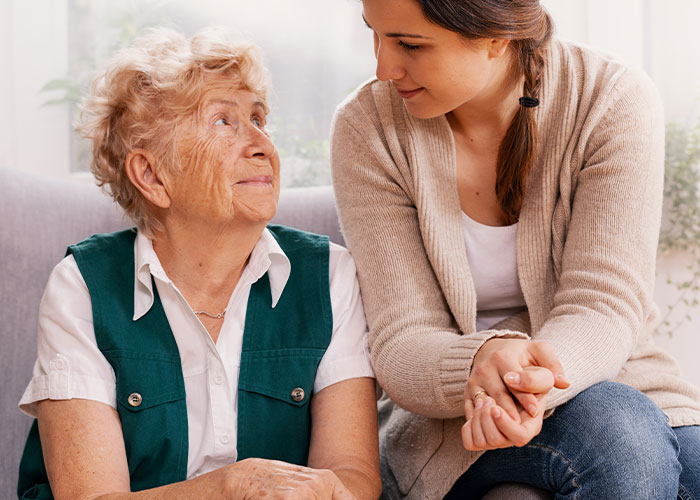 Elderly woman and younger woman sharing a heartfelt moment, capturing family emotions during Thanksgiving and divorce struggles.