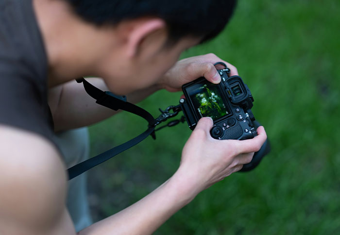 Person capturing unexpected moment on a DSLR camera, illustrating times people realized they aren’t supposed to see.