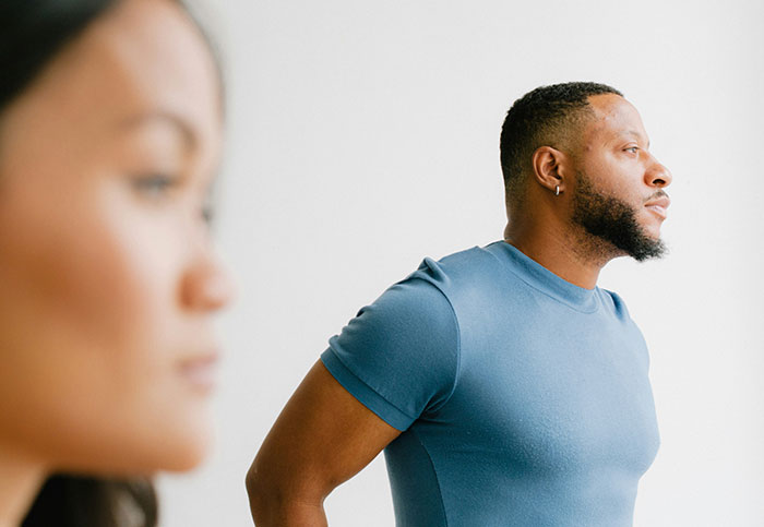 Two people in a bright room, one in focus looking ahead, illustrating moments people realized they shouldn’t see something.