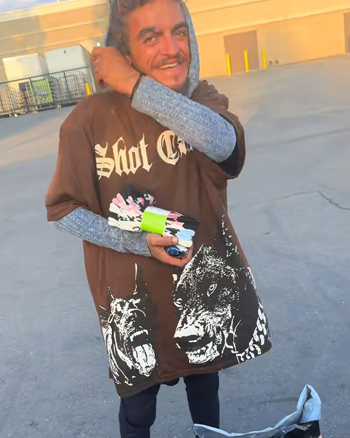 Man wearing graphic brown shirt and gray sleeves smiling outdoors, related to Daniel Curtis Lee homeless former co-star meeting.