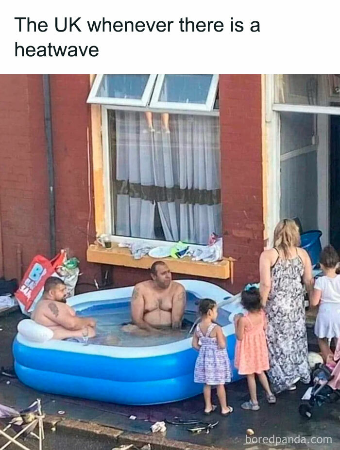 Two men sitting in a small inflatable pool on a British street during a heatwave with children and a woman nearby.