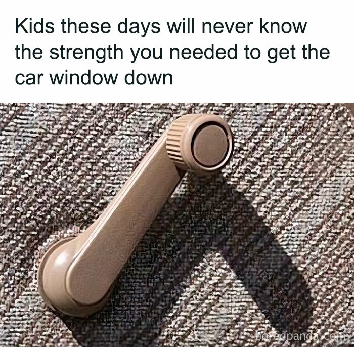 Manual car window crank on a textured door panel with a caption about strength, highlighting unapologetically British humor.