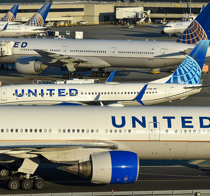 United Airlines planes parked at the gate with a focus on flight attendant and plus-size model fat-shaming debate context.