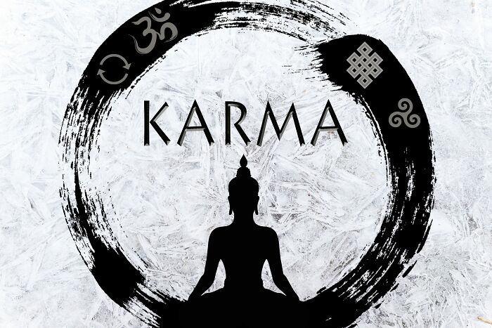 Silhouette of a meditating figure centered in a black circular brushstroke with spiritual symbols and karma text.