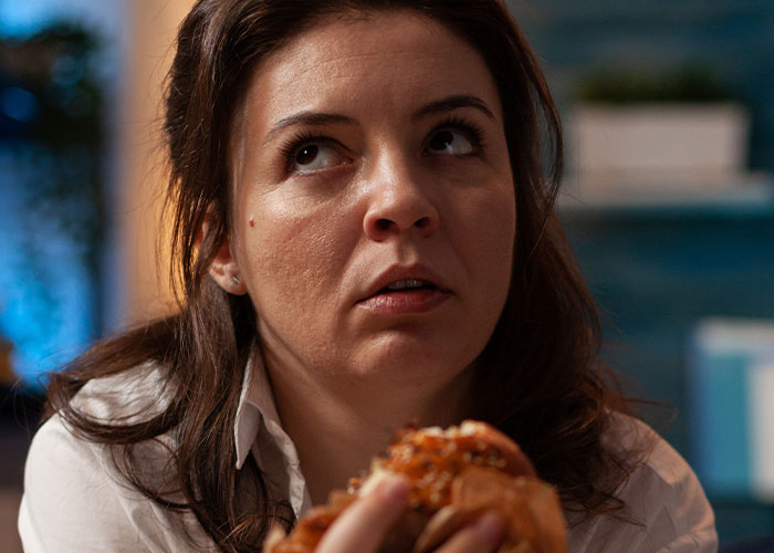 Bride looks disappointed holding a cupcake, highlighting issues with wedding vendors and allergy-related cupcake problems.
