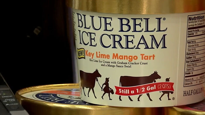 Blue Bell Ice Cream container close-up showing Key Lime Mango Tart flavor label and nutrition facts.