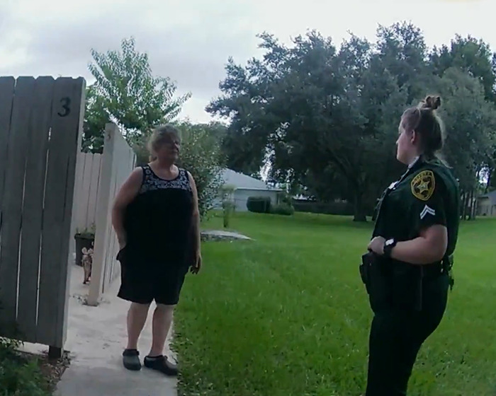 A police officer talking to a woman outside a house, related to Netflix&rsquo;s The Perfect Neighbor disturbing true story.