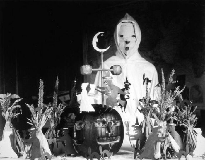 Vintage Halloween costume featuring a ghostly figure and classic pumpkin decorations from past Halloween costumes.
