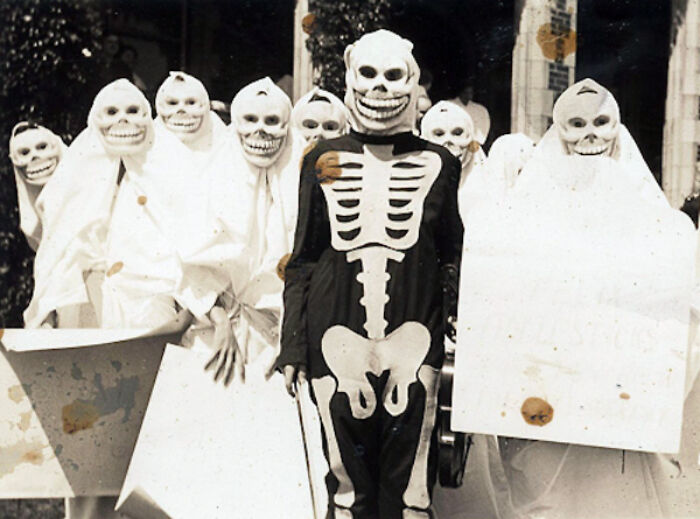 Group of vintage Halloween costumes featuring skeleton and ghost outfits, showcasing terrifying and impressive Halloween costumes from the past.
