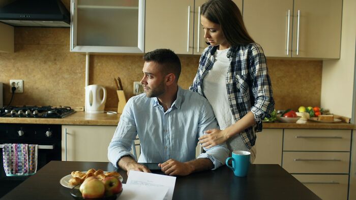 A couple sharing relationship advice in a kitchen, discussing important gems of relationship advice together.