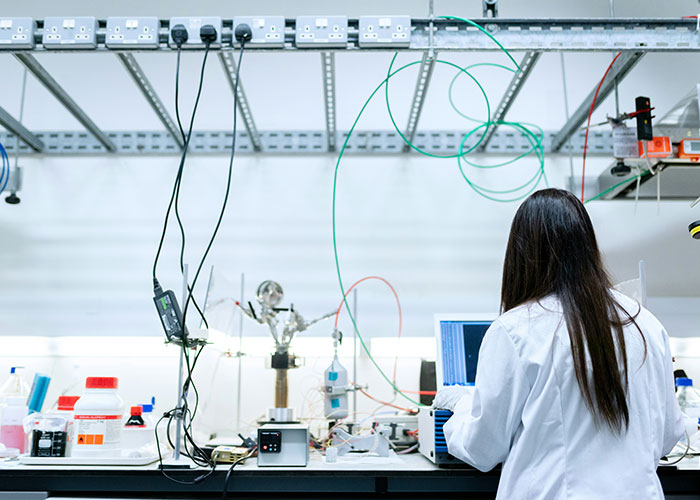 Scientist in a white coat conducting medical examinations in a lab setting uncovering truths about a person’s death.