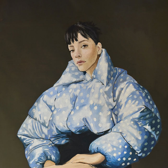 Portrait of Lily Allen wearing a blue polka dot jacket, related to Lily Allen brutal album about David Harbour discussion.