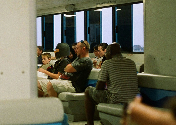 People sitting in a waiting area, showcasing diverse reactions capturing instant karma manifestations in everyday life.