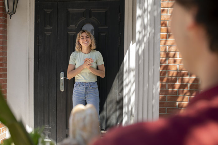 New homeowners enjoying their yard and pool privacy while neighbors look on from outside the fenced land.