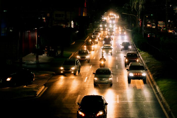 Nighttime traffic on a busy road with headlights shining, illustrating chaos linked to worst Halloween experiences.
