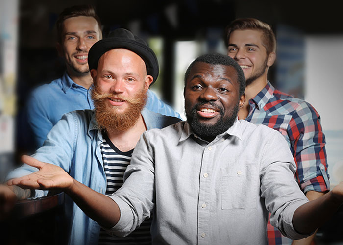 A diverse group of men sharing myths about men that are simply not true in a casual indoor setting.