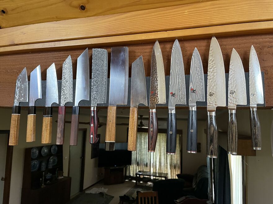 Magnetic knife holder displaying various kitchen knives, showcasing an effective organization hack for home storage.