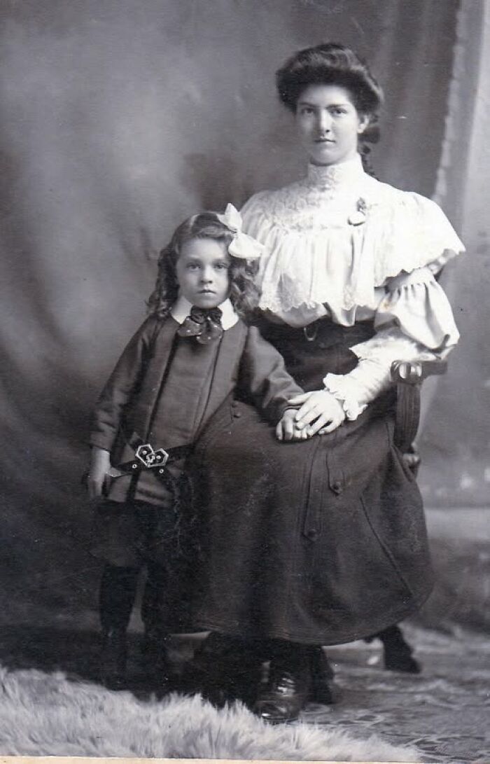 Victorian-Edwardian pictures of a woman seated and a child standing beside her, both in period clothing holding hands.