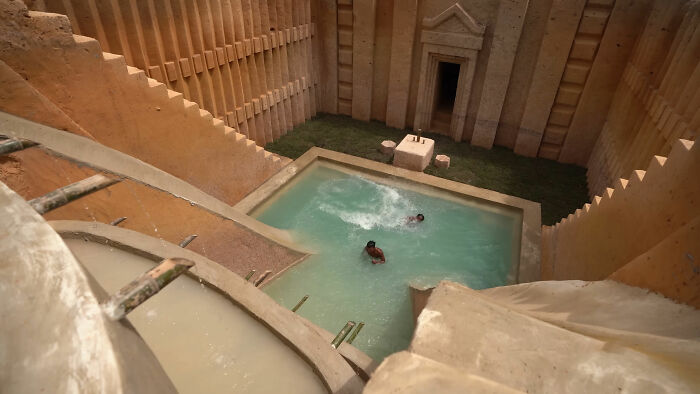 Ancient stepwell with two people swimming, illustrating the depth and darkness of internet rabbit holes that consume lives.