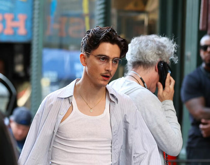 Timothée Chalamet in casual attire looking pensive during a public moment related to psychosis and Zoom call discussions. Timothée Chalamet in casual attire looking pensive during a public moment related to psychosis and Zoom call discussions.