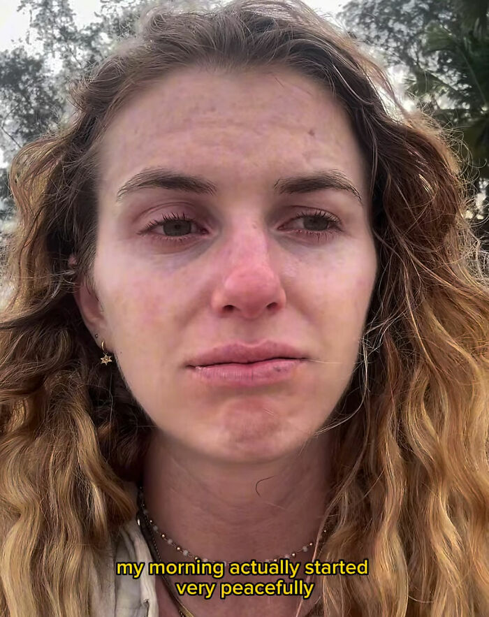 Woman with distressed expression outdoors reflecting on solo traveling experience after recording local man's vile act.