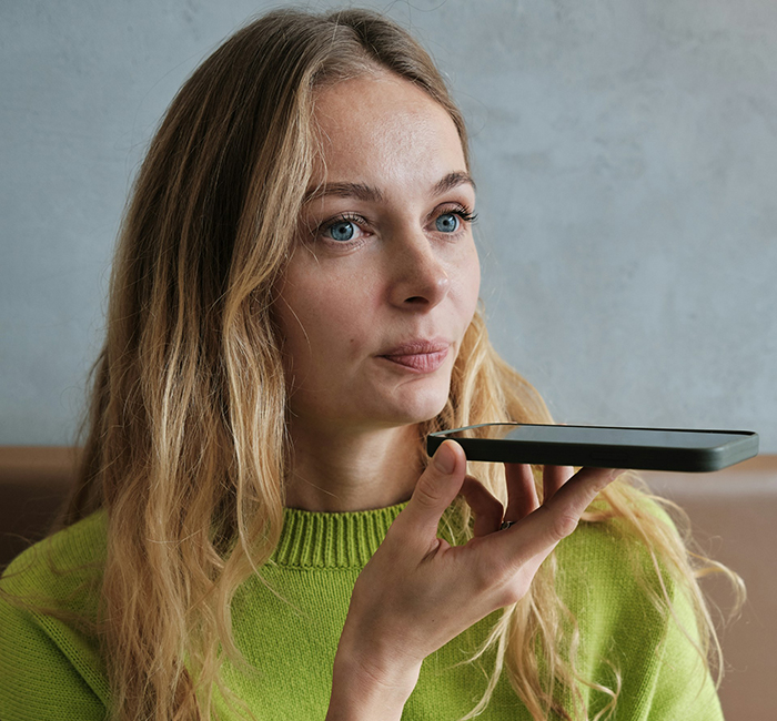 Young woman in green sweater speaking on speakerphone, showing petty revenge on husband’s coworker attempt to seduce him Young woman in green sweater speaking on speakerphone, showing petty revenge on husband’s coworker attempt to seduce him