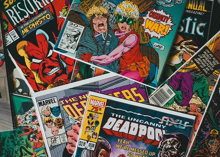 Collection of vintage comic books featuring superheroes, one of the fascinating items people found in the walls of their homes.