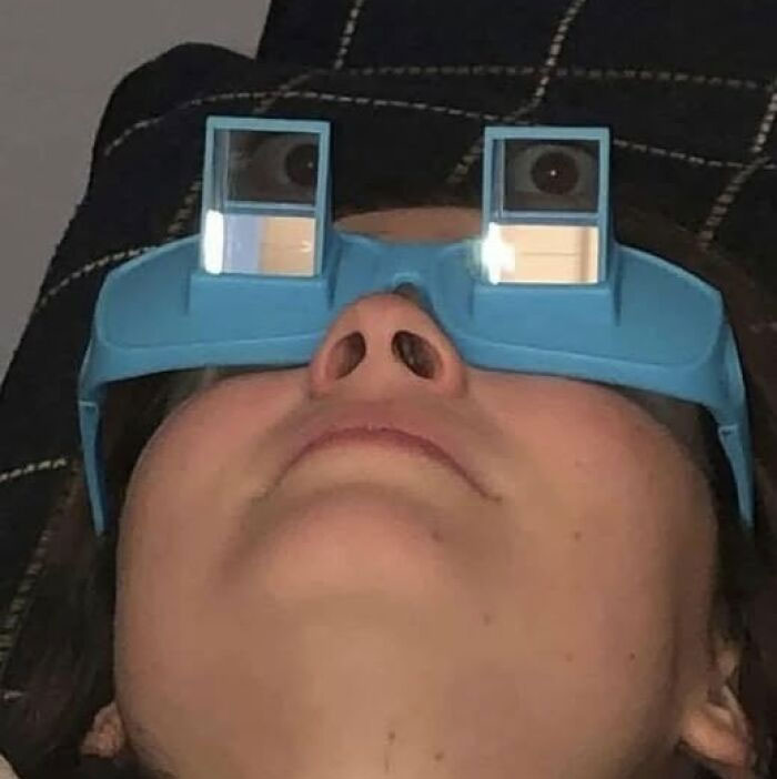 Person wearing novelty glasses with mirrors reflecting their eyes, a quirky and funny pic that goes hard.