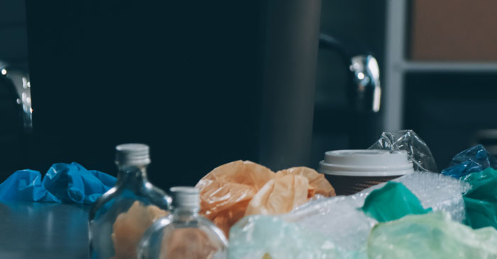 Trash bin overflowing with various waste, symbolizing chaotic and wild family drama shared online.