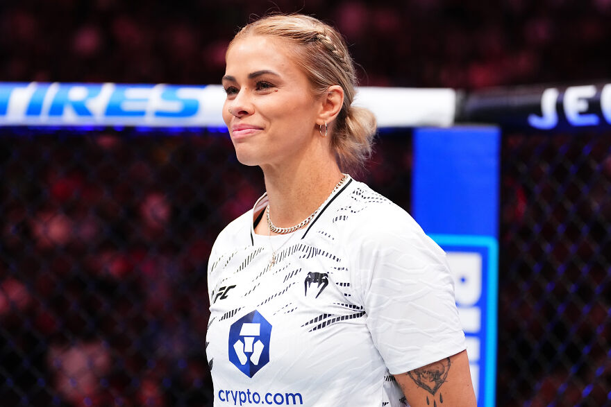 Paige Vanzant athlete smiling inside MMA cage, representing celebrities featured on members-only fan pages.