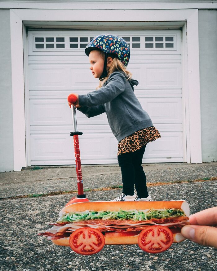 Child on scooter with a sandwich paper cutout using tomato slices as wheels, illustrating paper cutouts interacting with real life.