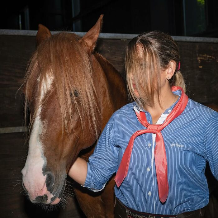 Woman and horse with matching hair color and style, showcasing pets and their humans looking shockingly alike.