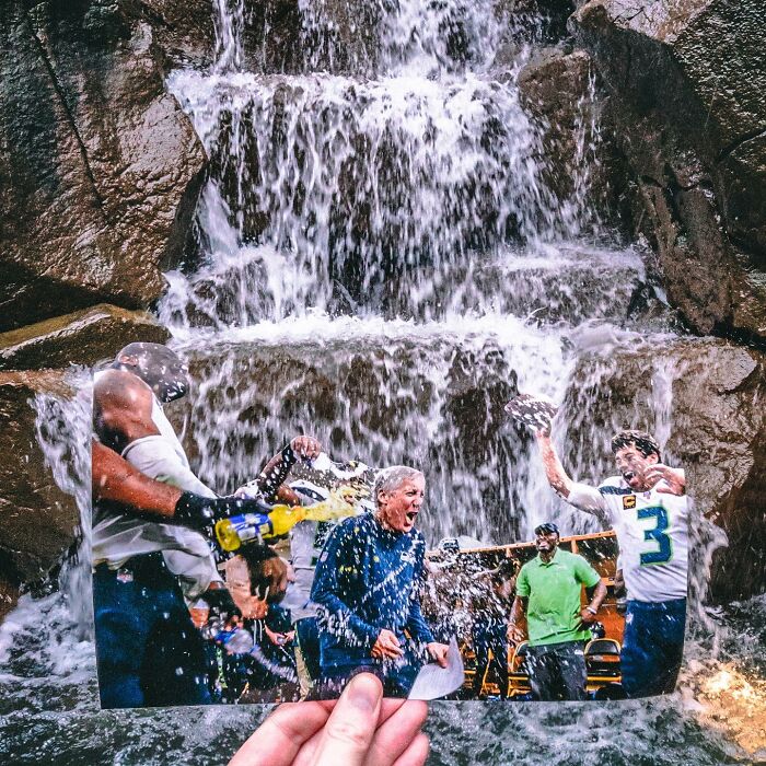 Hand holding a paper cutout of people interacting under a waterfall, showcasing brilliant paper cutouts art.