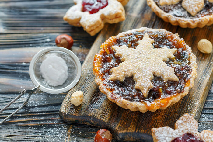 Close-up of festive Thanksgiving desserts on a wooden board highlighting popular holiday food and mashed potatoes debates.