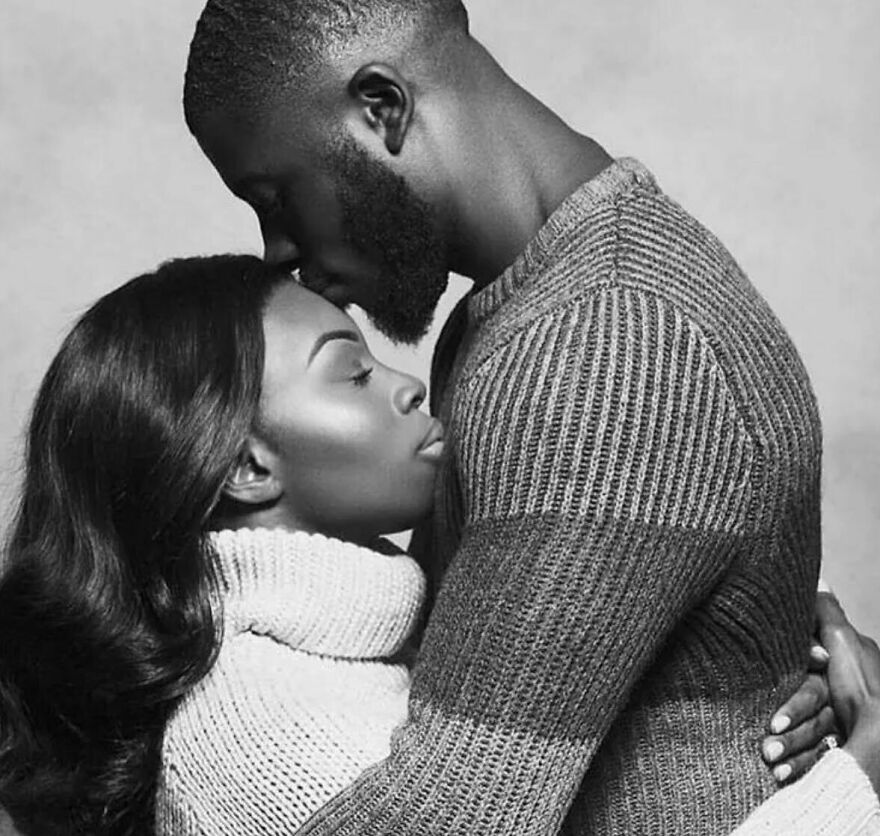 Couple embracing with a gentle forehead kiss, illustrating intimate types of kisses in culture and history.