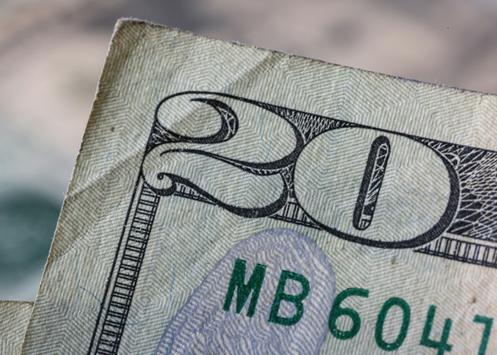 Close-up of a wrinkled 20-dollar bill representing the concept of horrible gifts people have actually received.