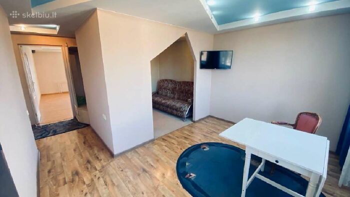 Small living space with outdated furniture and unusual layout featured in wild real estate listings for property sales.