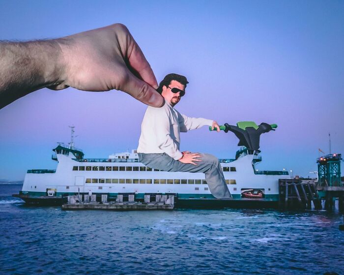 Hand holding a paper cutout figure interacting with a ferry, showcasing Rudy Willingham’s brilliant paper cutouts art.