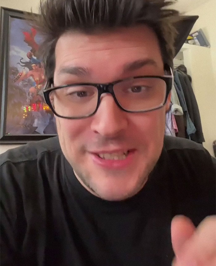 Man with glasses and spiked hair smiling and speaking indoors, relating to U.S. soldiers and hilarious letters kids send them.