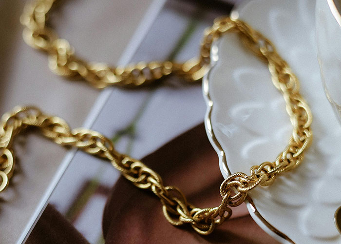 Gold chain necklace found hidden inside the walls of a home showcasing fascinating items discovered during renovations.