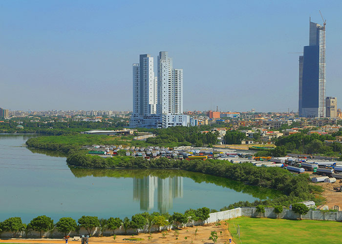 City skyline with high-rise buildings and a river, showcasing one of the worst cities worldwide you should never visit.
